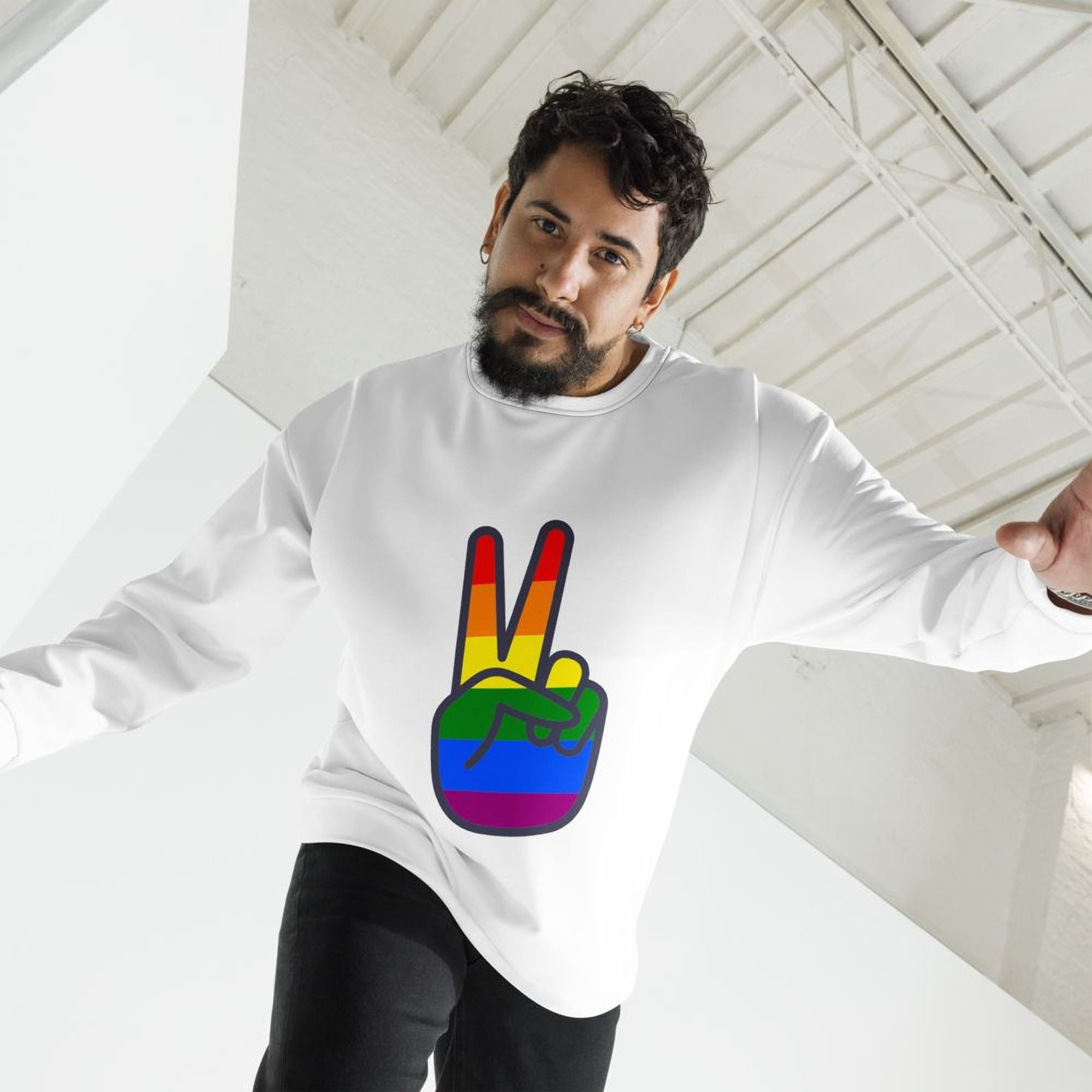 A man wearing a white sweatshirt with a peace sign graphic on it.