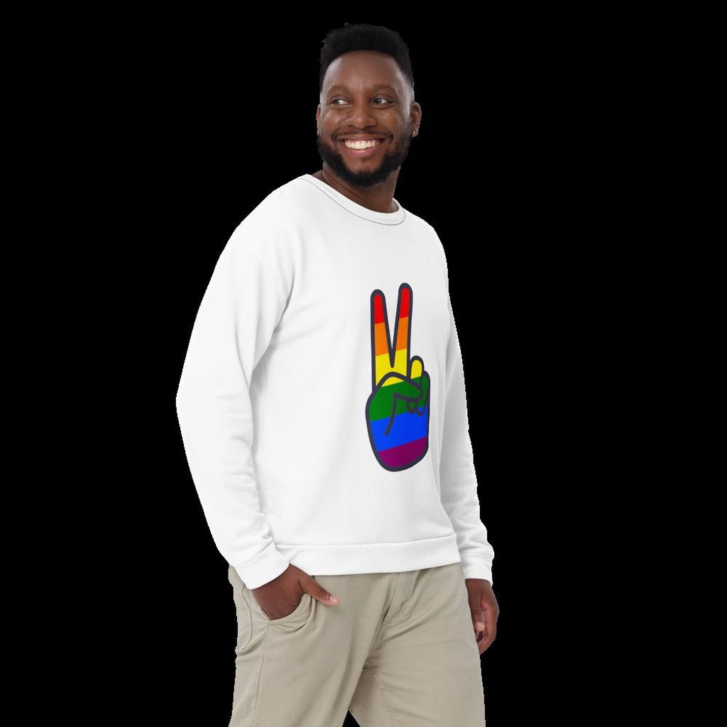A smiling man wearing a white sweatshirt with a peace sign graphic on it.