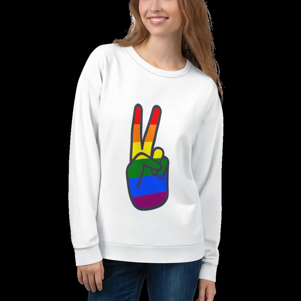 A woman wearing a white sweater with a peace sign graphic printed on it.