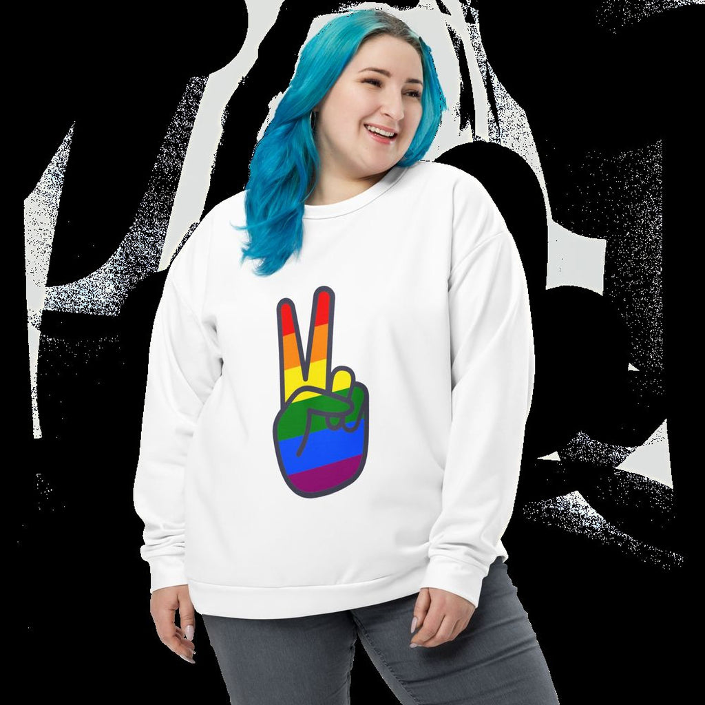 A woman with blue hair is smiling and wearing a white sweatshirt with a peace sign graphic on it.